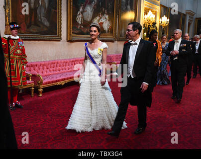 The Duchess of Cambridge and United States Secretary of the Treasury, Steven Mnuchin arrive through the East Gallery during the State Banquet at Buckingham Palace, London, on day one of the US President's three day state visit to the UK. Stock Photo