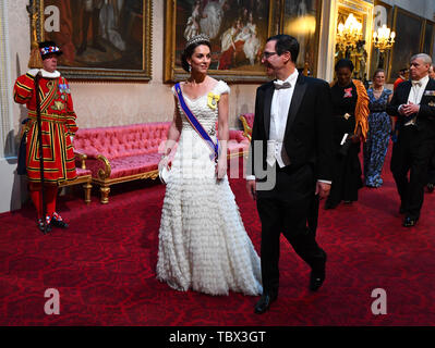 The Duchess of Cambridge and United States Secretary of the Treasury, Steven Mnuchin arrive through the East Gallery during the State Banquet at Buckingham Palace, London, on day one of the US President's three day state visit to the UK. Stock Photo