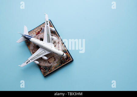 Vacation concept. Passport and plane on blue background. Flat lay. Top view. Copy space. Stock Photo