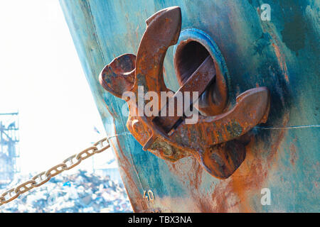 ship anchor in up position. Heavy metal anchor on the side of the ship. Stock Photo