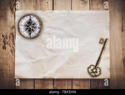 Old key and Compass on Old paper vintage on wood background with space Stock Photo