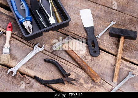 Old construction tools on rustic wooden boards. Various tools and instruments for repair. Stock Photo