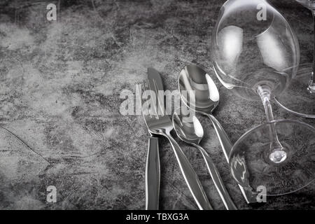 Knives, forks, spoons and empty glass glasses and plates on the table Stock Photo