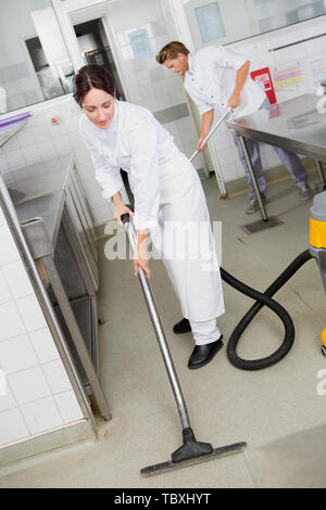 professional cleaning service in uniforms at work Stock Photo