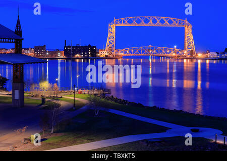 The night view of Aerial Lift Bridge with Bayfront Festival Park and Duluth harbor basin in foreground. Duluth.Minnesota.USA Stock Photo