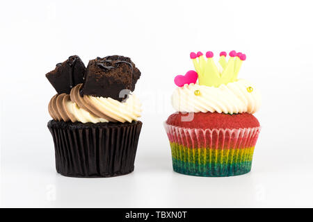 Chocolate brownie and raibow cupcake isolated on white background Stock Photo