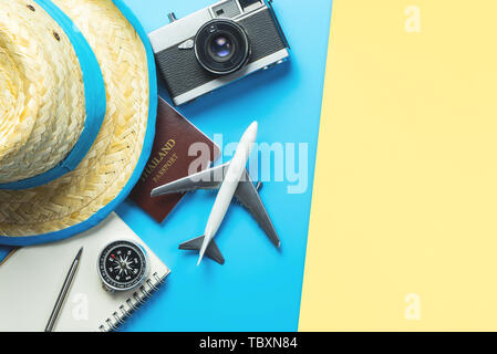 Travel accessories objects and gadgets top view flatlay on blue yellow Stock Photo