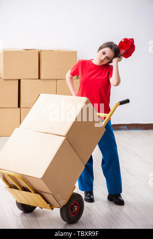 Young female professional mover doing home relocation Stock Photo