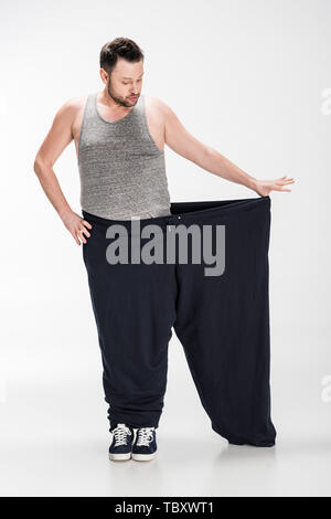 Premium Photo | Woman showing her big trousers after successful diet and weight  loss