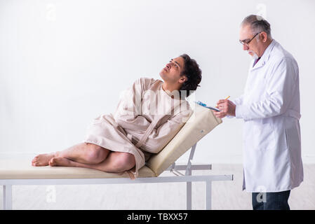 The aged male doctor psychiatrist examining young patient Stock Photo