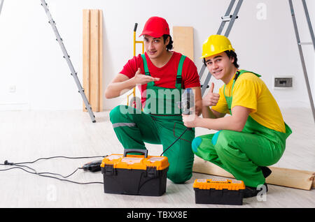 Two workers contractors working indoors Stock Photo
