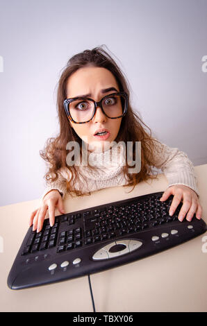 Funny nerd girl working on computer Stock Photo