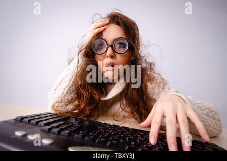 Funny nerd girl working on computer Stock Photo