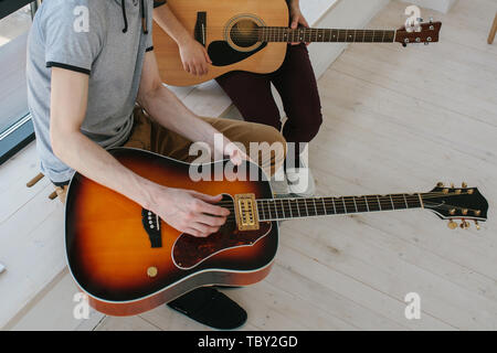 Learning to play the guitar. Extracurricular activities or tutoring or hobbies or creative activities. Stock Photo