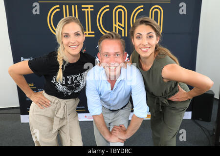 Magdeburg, Germany. 04th June, 2019. Sandy Mölling Ex No Angels member, Daniel Rakasz and Marcella Adema pose in front of a poster during the press conference of the Domplatz-Open-Air 'Chicago' of the Theater Magdeburg. The open-air musical 'Chicago' will take place from 14 June to 07 July 2017. Credit: Peter Gercke/dpa-Zentralbild/ZB/dpa/Alamy Live News Stock Photo