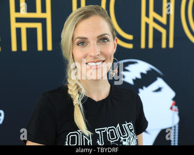 Magdeburg, Germany. 04th June, 2019. Sandy Mölling, former 'No Angels' member, stands in front of a poster during the press conference of the Domplatz-Open-Air 'Chicago' of the Theater Magdeburg. The open-air musical 'Chicago' will take place from 14 June to 07 July 2017. Credit: Peter Gercke/dpa-Zentralbild/ZB/dpa/Alamy Live News Stock Photo