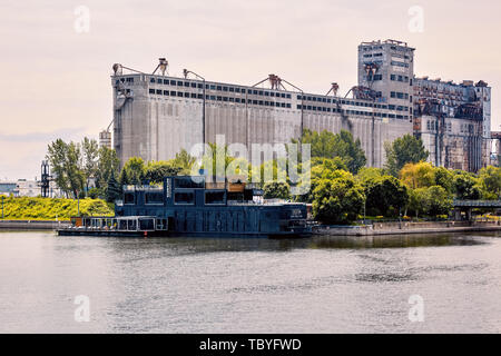 Montreal, Canada - June, 2018: Bota bota spa and historical grain factory silo No.5 on st. lawrence river in old port, Montreal, Quebec, Canada. Edito Stock Photo