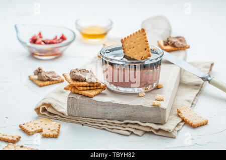 Liver pate with crisps on a white background. Selective focus Stock Photo