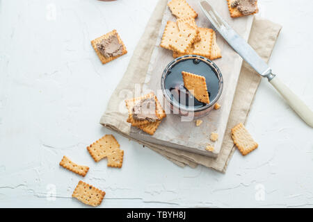 Top view of liver pate with crisps on white back with copy space. Stock Photo