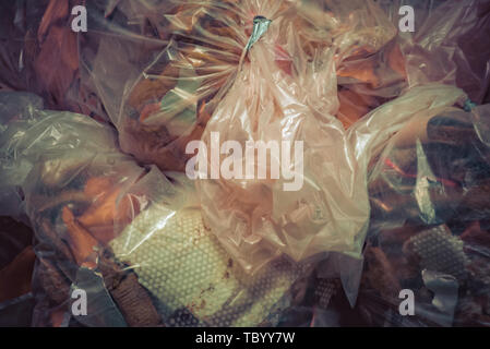Lots of garbage in plastic bags thrown in a heap Stock Photo