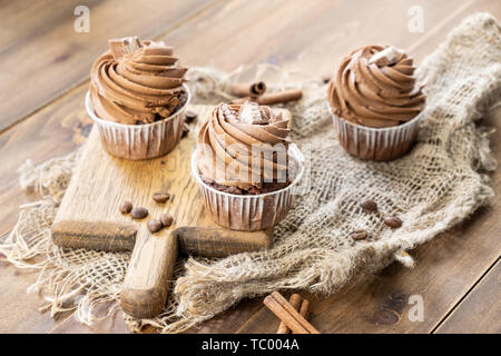 brown cupcakes with cocoa cream, cinnamon and coffee Stock Photo