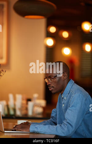 Side view portrait of african man standing over white background Stock ...