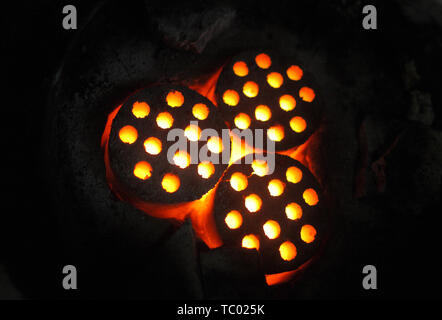 Honeycomb coal burning in the stove. Stock Photo