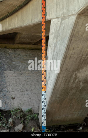 Flood measuring slat on a bridge Stock Photo