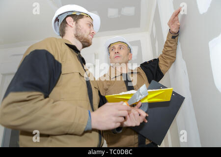 two builders making finish in the apartment Stock Photo