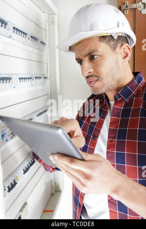 electrician engineer holding tablet computer Stock Photo