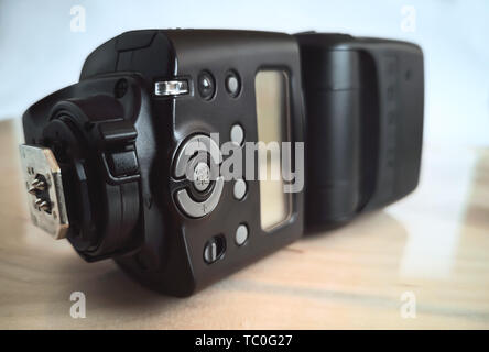 Close-up presents a modern flash to the SLR camera for better lighting when shooting Stock Photo