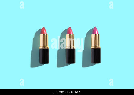 Set of color lipsticks on color background. Flat lay, top view