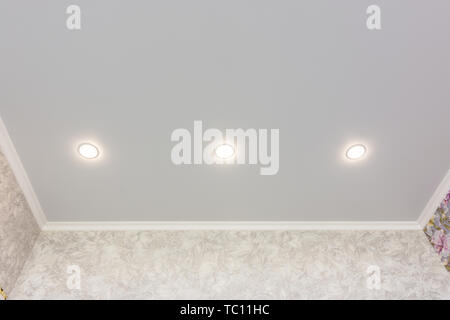 Three spotlights built into the suspended ceiling Stock Photo