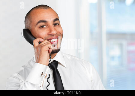 happy businessman talking on landline phone Stock Photo