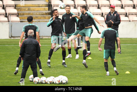 Portugal's Cristiano Ronaldo (left) Watches On As The Ball Enters The 