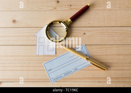 Banking Check with magnifier glass Stock Photo