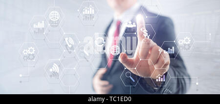 Double exposure mixed media. Diagrams and icons on hologram screen. Business people and modern city on background. Stock Photo