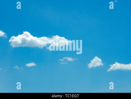 There are a few white clouds in the deep blue sky. Stock Photo