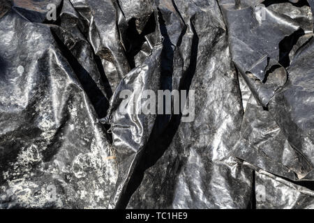 Black foil plastic surface texture Stock Photo