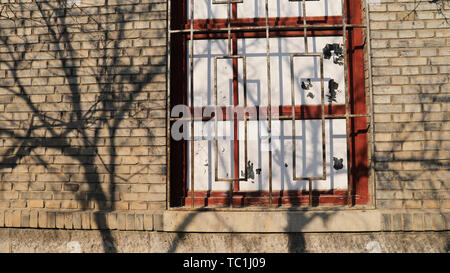 Nostalgic brick walls, mottled tree shadows Stock Photo