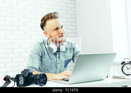 Photographer selecting photos on his computer Stock Photo