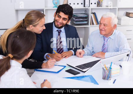 Managers are writing financial reports in the office. Stock Photo