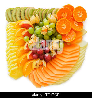 Mix of arranged freshly cut tropical and citrus fruit isolated on white from above. Stock Photo
