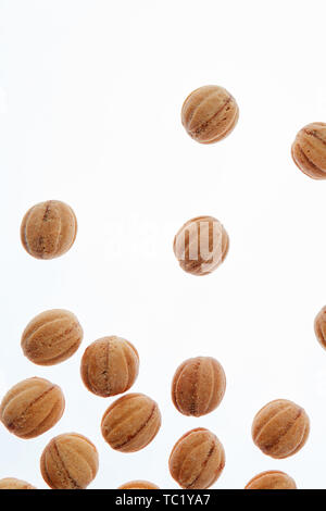 Falling homemade cookies walnuts on a white background. Stock Photo