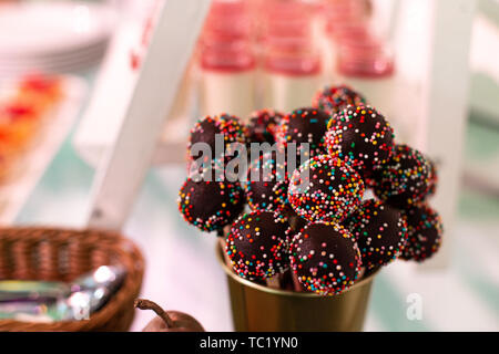 Candy bar. Sweets on a stick with sprinkles. Selective focus. Stock Photo