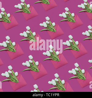 Decorative background with gift envelopes of tulips flowers on a magenta. Stock Photo
