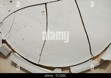 Top view background of cracked ceramic plate on wooden table in pottery workshop, copy space Stock Photo
