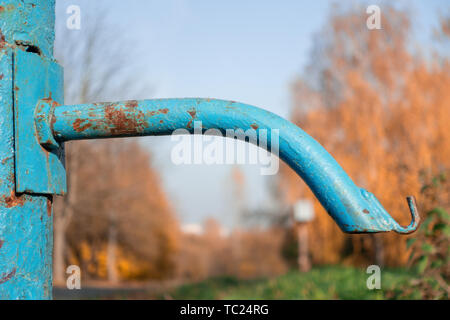 broken old drinking column in the village. drought, no water. close. in the background autumn trees. Stock Photo