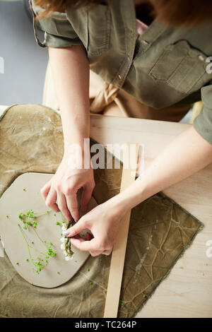 High angle view of contemporary female artisan creating handmade ceramics in pottery studio, copy space Stock Photo