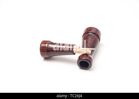 A Ducks Unlimited wooden game or duck call, separated to show single reed sound apparatus. Stock Photo